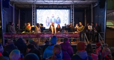 Im Hintergrund die Stadtkapelle Kolbermoor, davor Stadtpfarrer Maurus Scheurenbrand, Bürgermeister Peter Kloo und Organisator Alexander Heinold
